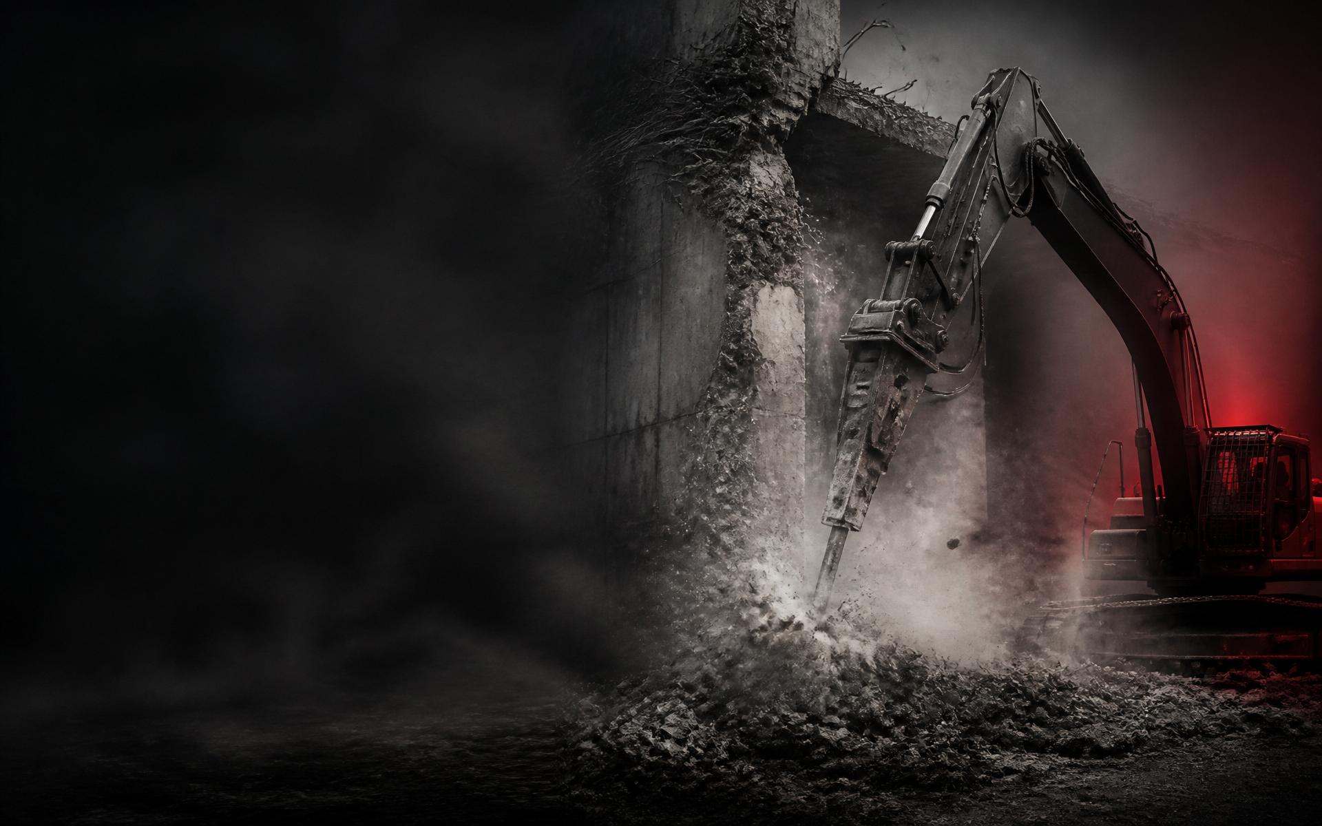 Excavator with hydraulic breaker tearing down a concrete wall in a cloud of dust